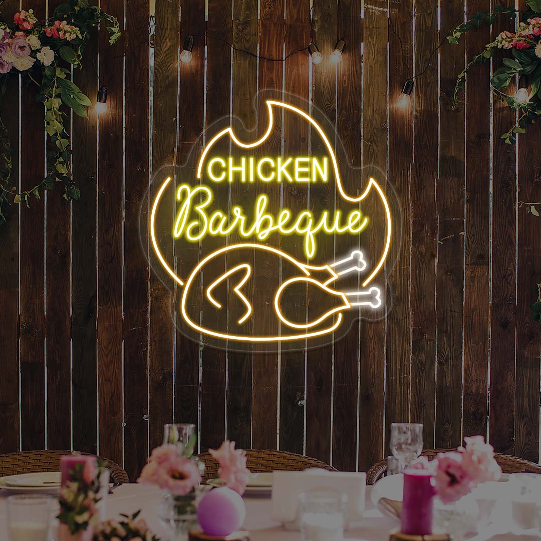 Neon sign with 'Chicken Barbeque' text on a wooden wall with floral decorations.